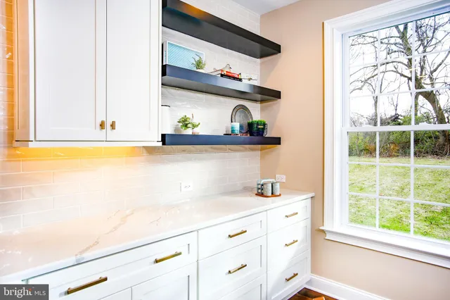a large kitchen with a table and chairs