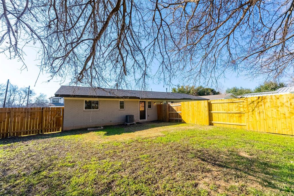 4306 Shallowbrook Trail Austin, TX 78744 - Photo 15 of 16 a backyard of a house with swimming pool and wooden fence