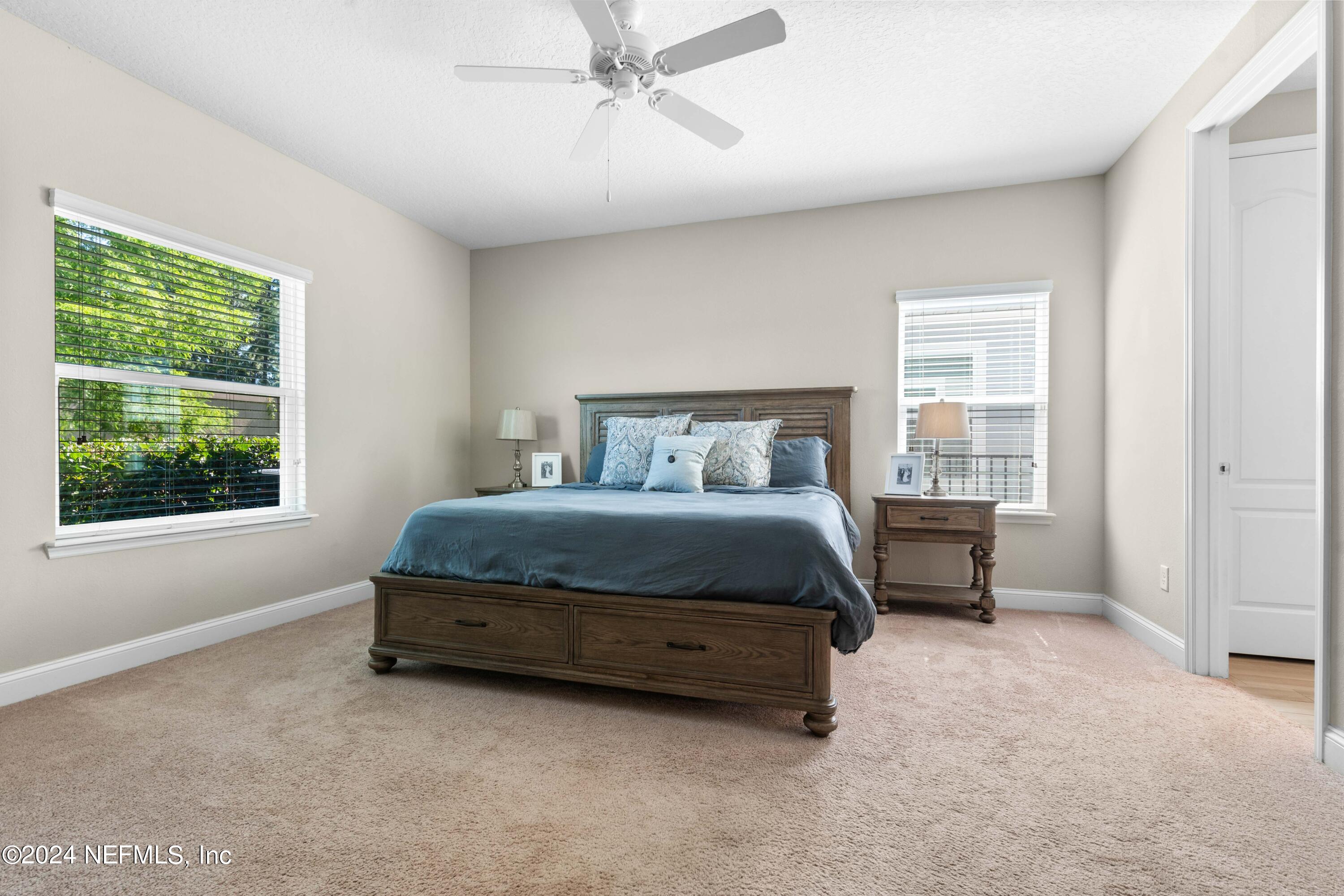 2672 Alexia Circle Jacksonville, FL 32246 - Photo 13 of 33 a bedroom with a bed chair and window