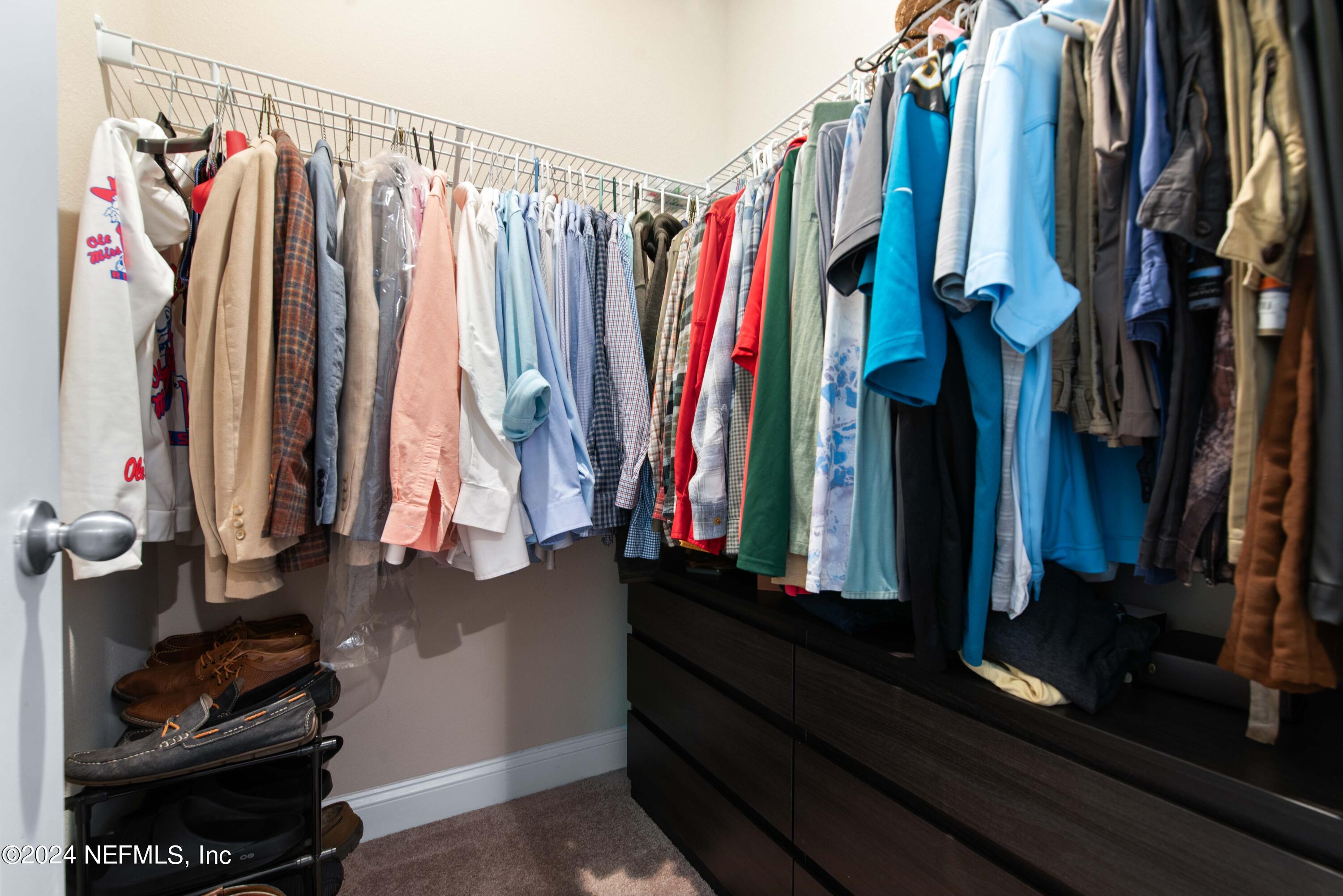 2672 Alexia Circle Jacksonville, FL 32246 - Photo 17 of 33 a view of walk in closet with clothes