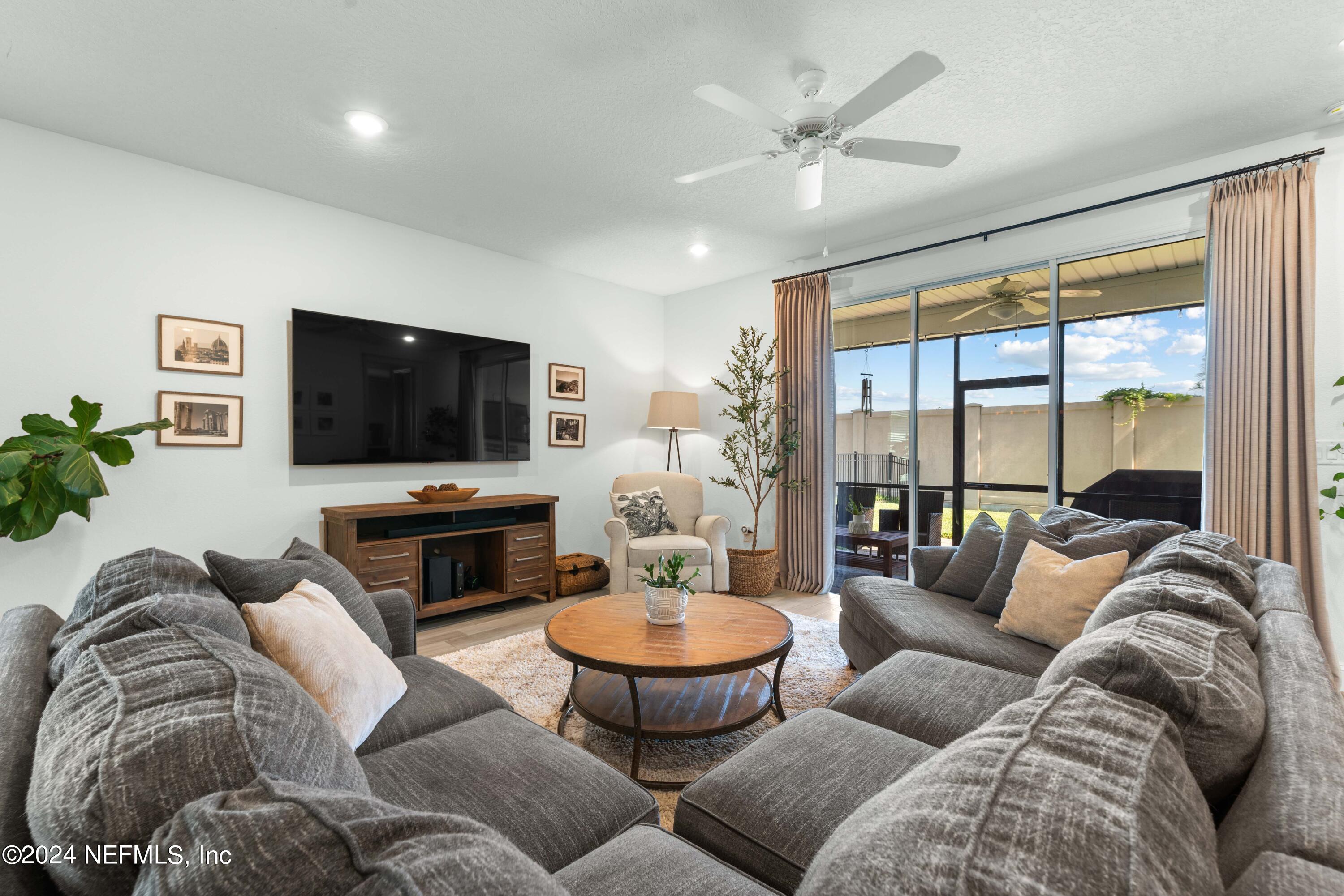 2672 Alexia Circle Jacksonville, FL 32246 - Photo 8 of 33 a living room with furniture and a flat screen tv
