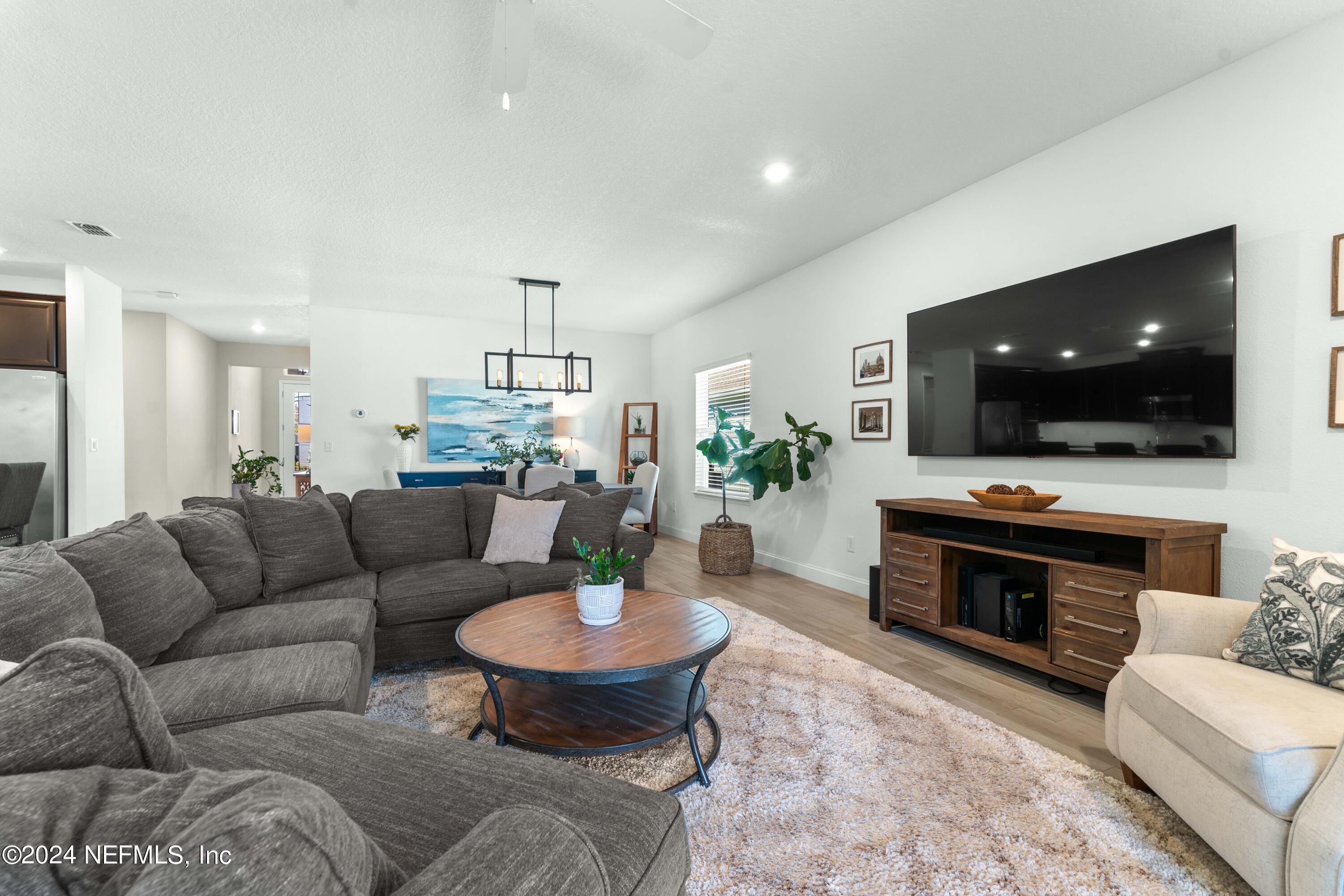 2672 Alexia Circle Jacksonville, FL 32246 - Photo 9 of 33 a living room with furniture and a flat screen tv
