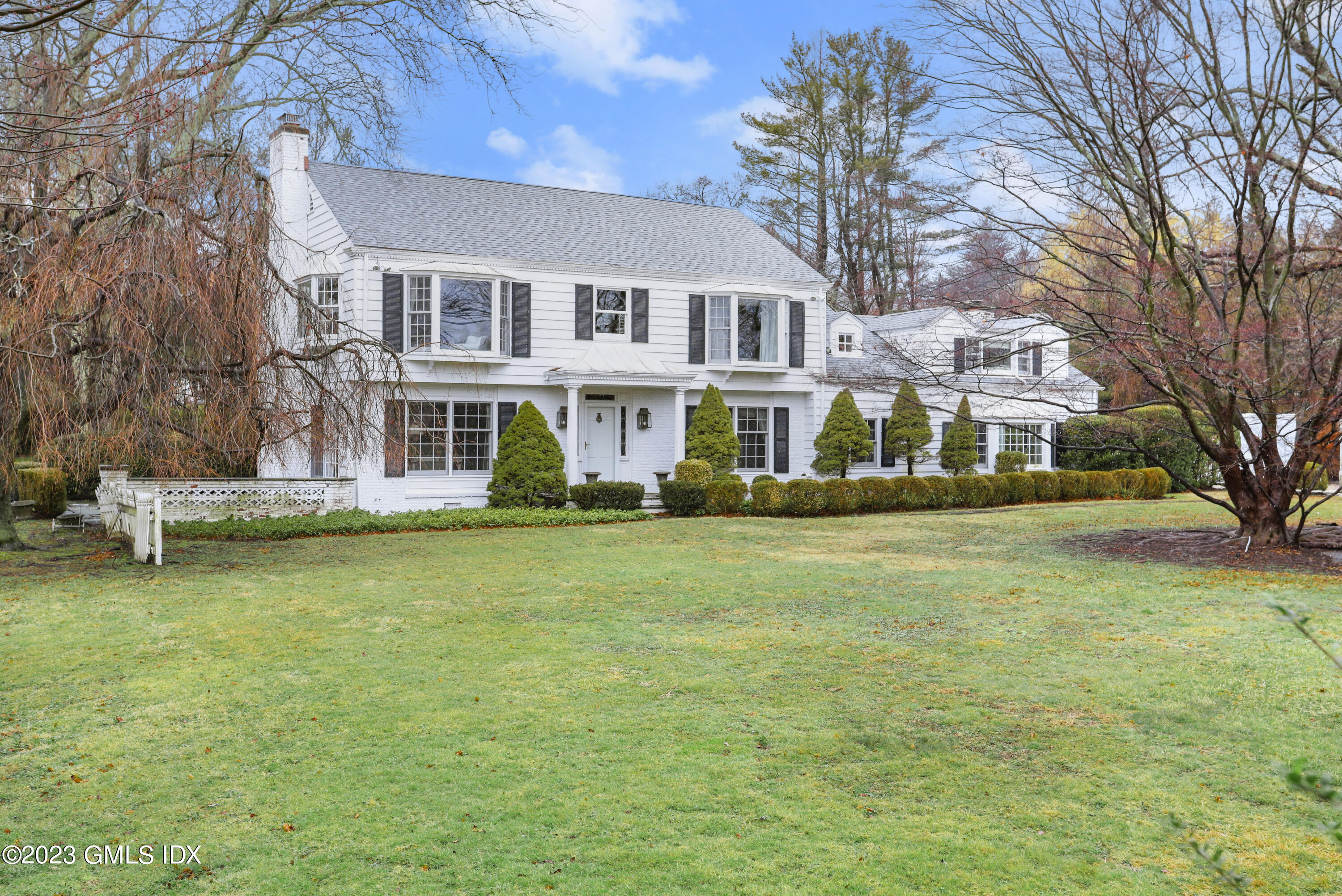 a front view of a building with a garden
