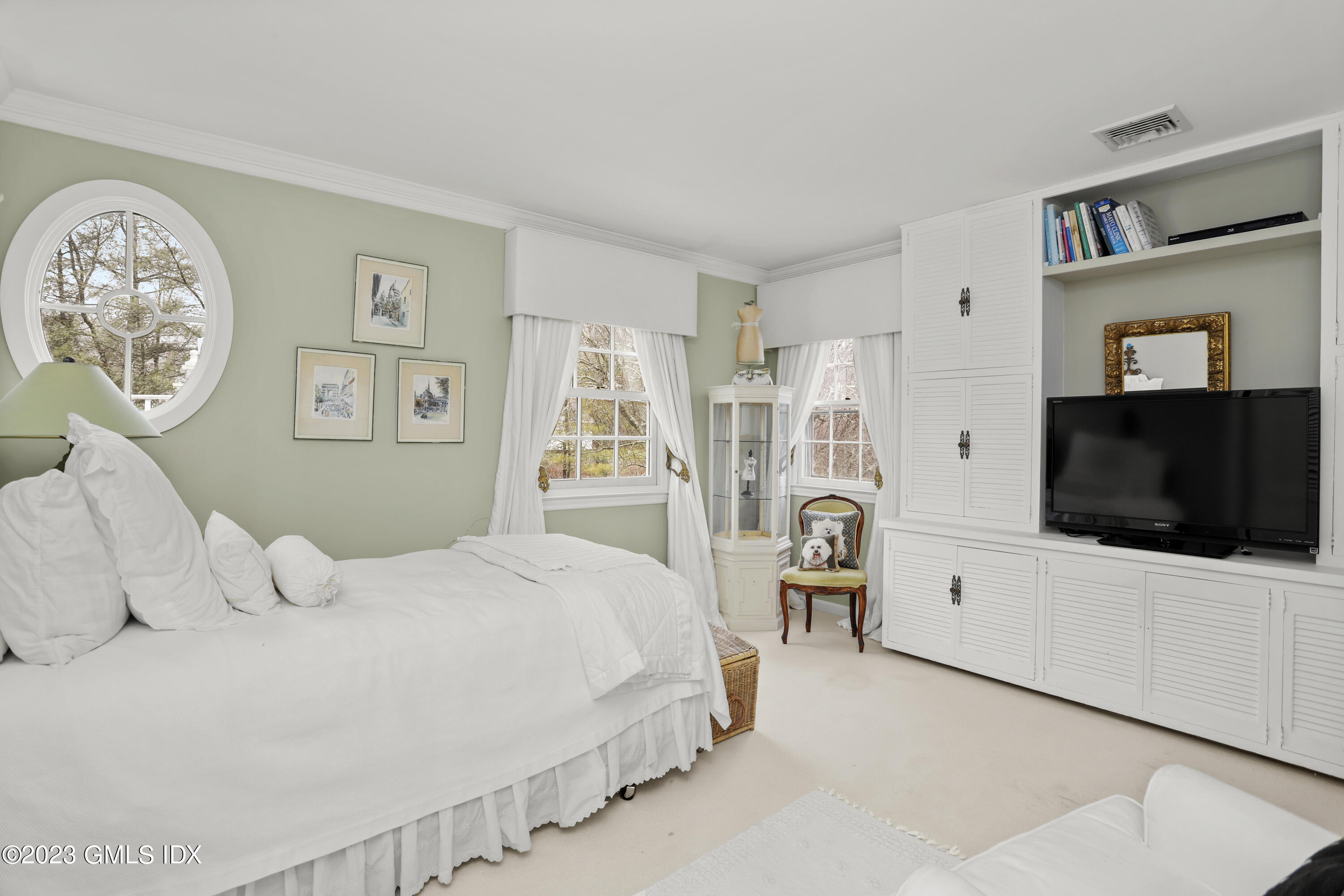 36 Golf Club Road Greenwich, CT 06830 - Photo 23 of 32 a bedroom with a flat screen tv and a bed