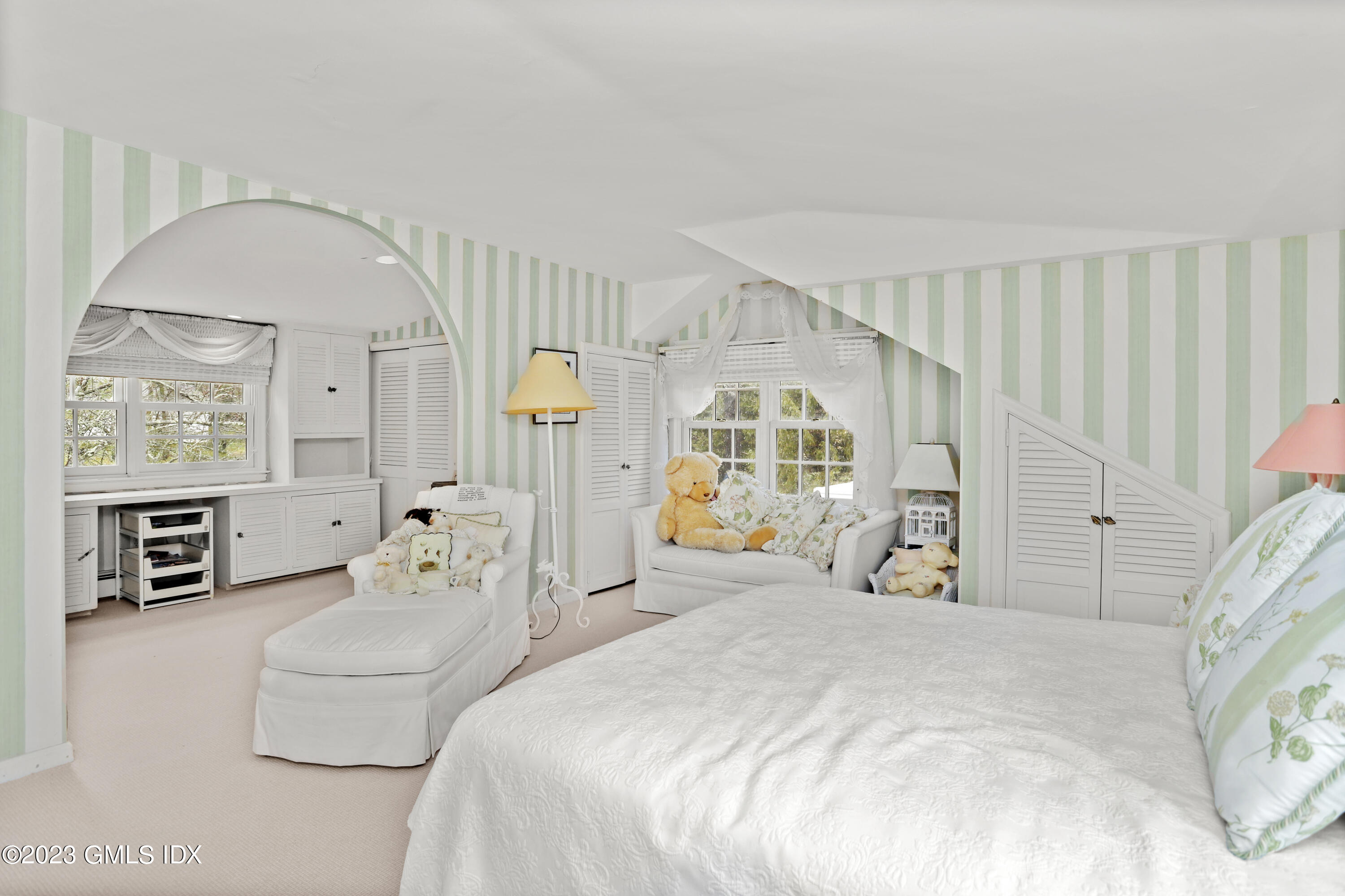 36 Golf Club Road Greenwich, CT 06830 - Photo 24 of 32 a spacious bedroom with a bed a table and large window