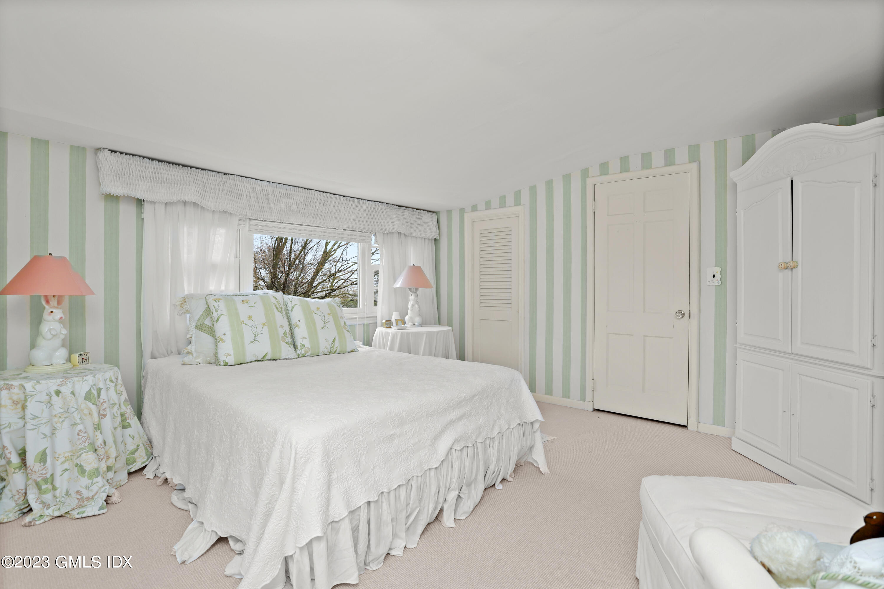 36 Golf Club Road Greenwich, CT 06830 - Photo 25 of 32 a bedroom with a bed and a chandelier