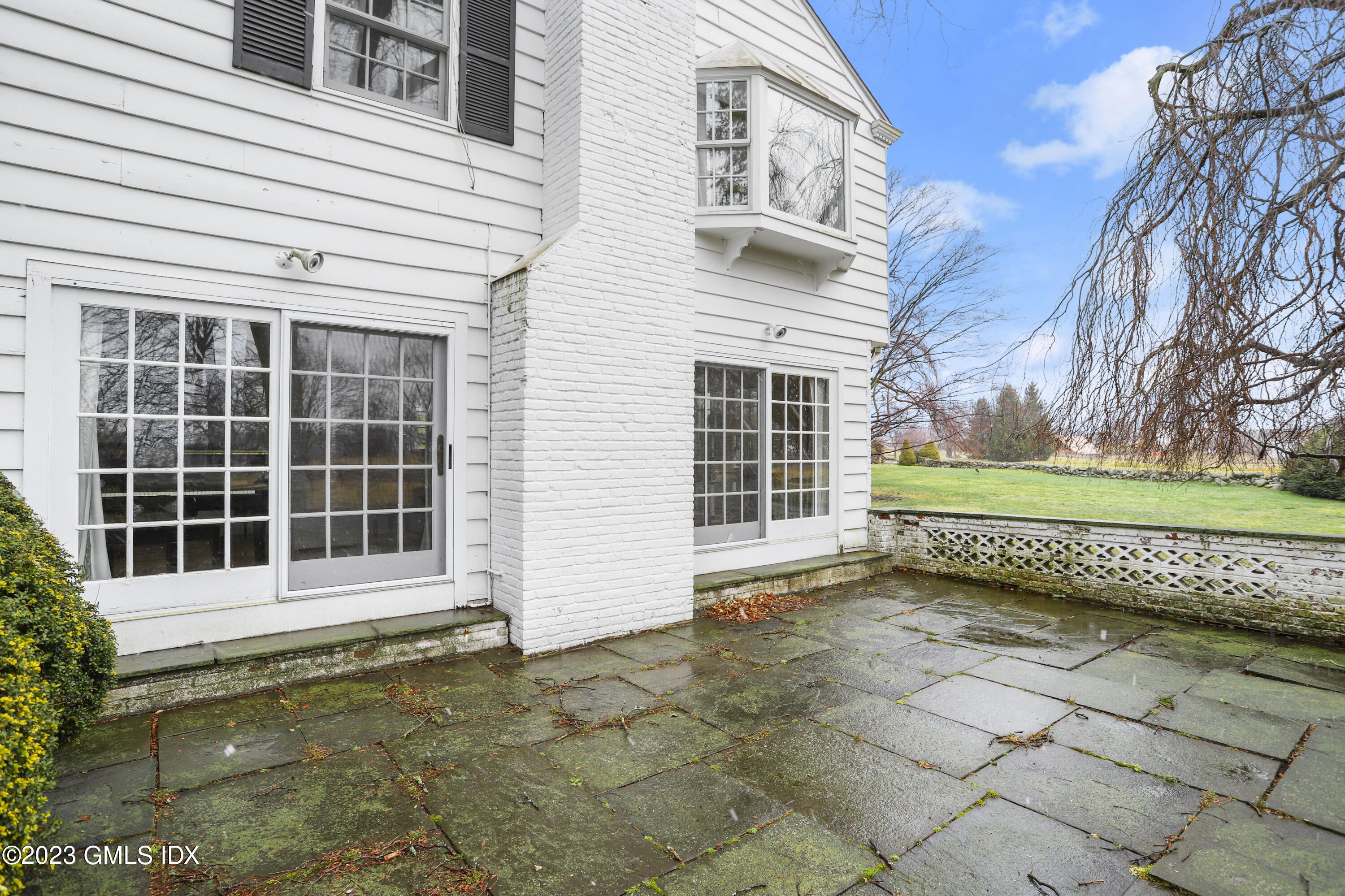36 Golf Club Road Greenwich, CT 06830 - Photo 29 of 32 a view of a house with a large window and wooden fence