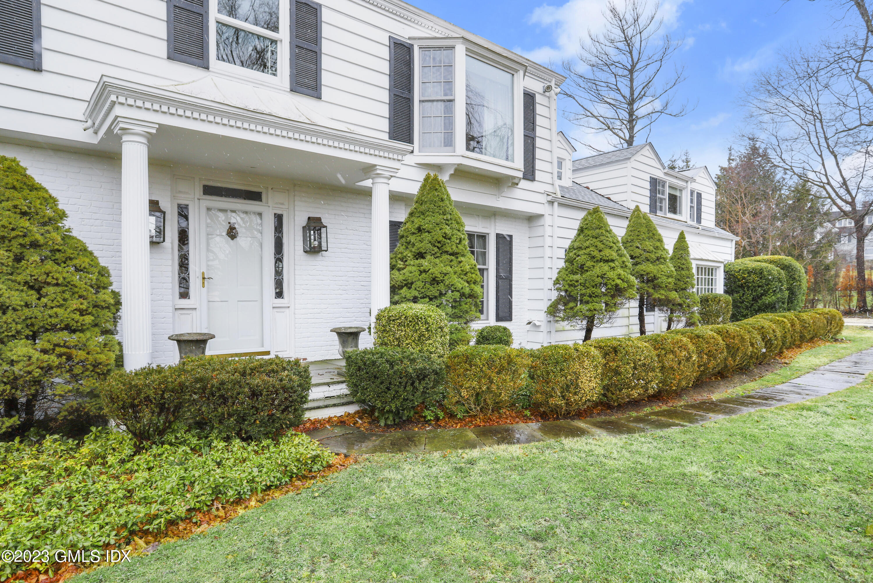 36 Golf Club Road Greenwich, CT 06830 - Photo 30 of 32 a front view of a house with a yard
