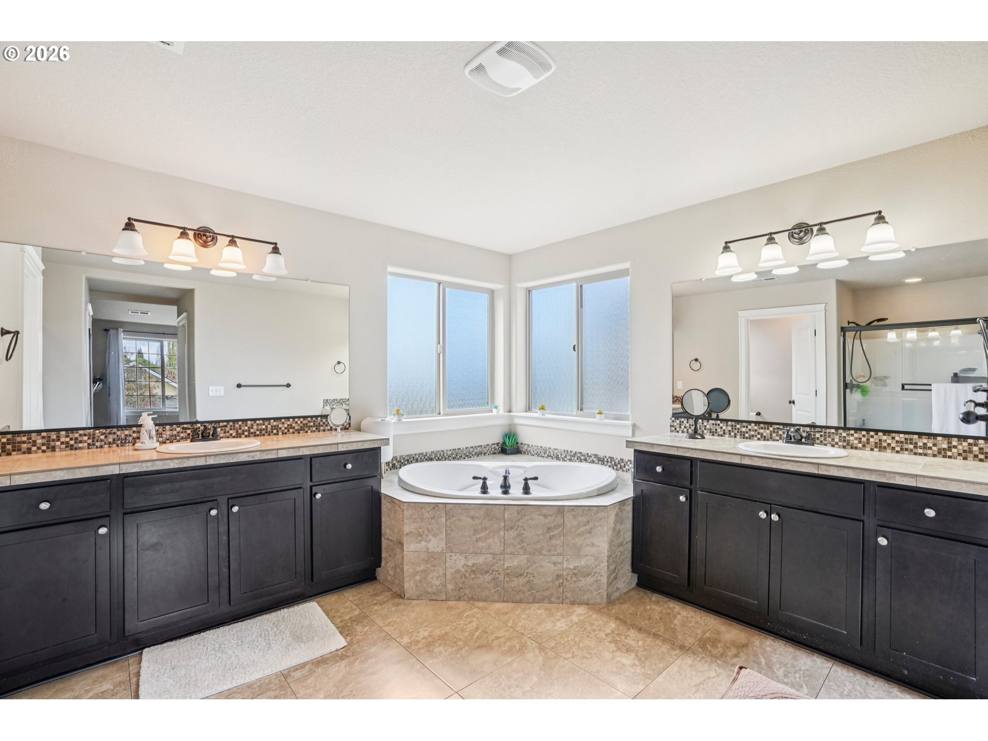16958 Southwest Kavitt Lane Beaverton, OR 97078 - Photo 17 of 30 a large bathroom with a large tub vanity and sink