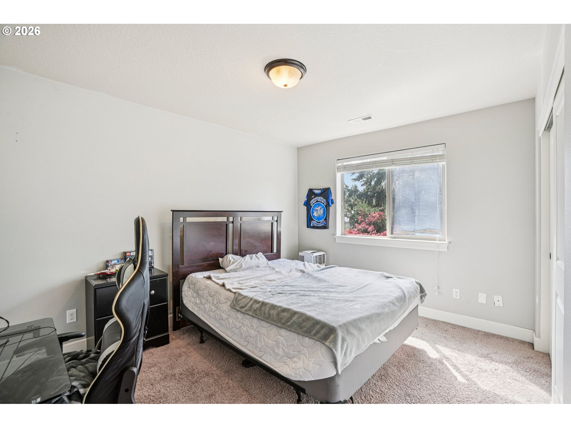 16958 Southwest Kavitt Lane Beaverton, OR 97078 - Photo 21 of 30 a bedroom with a bed and a window