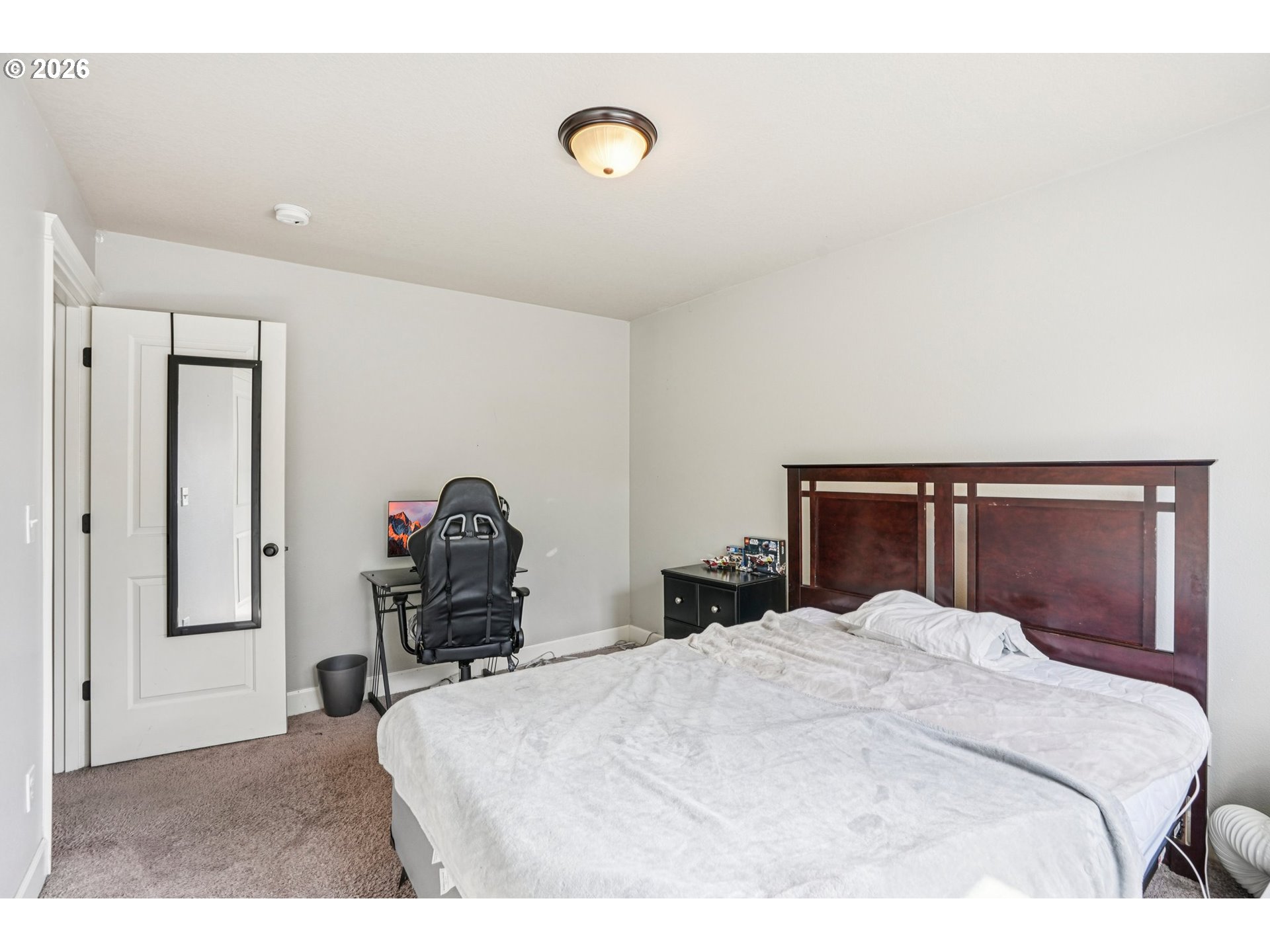 16958 Southwest Kavitt Lane Beaverton, OR 97078 - Photo 22 of 30 a bedroom with a bed and a dresser