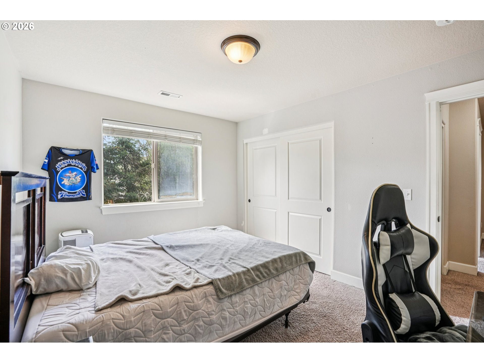 16958 Southwest Kavitt Lane Beaverton, OR 97078 - Photo 23 of 30 a bedroom with a bed and a window