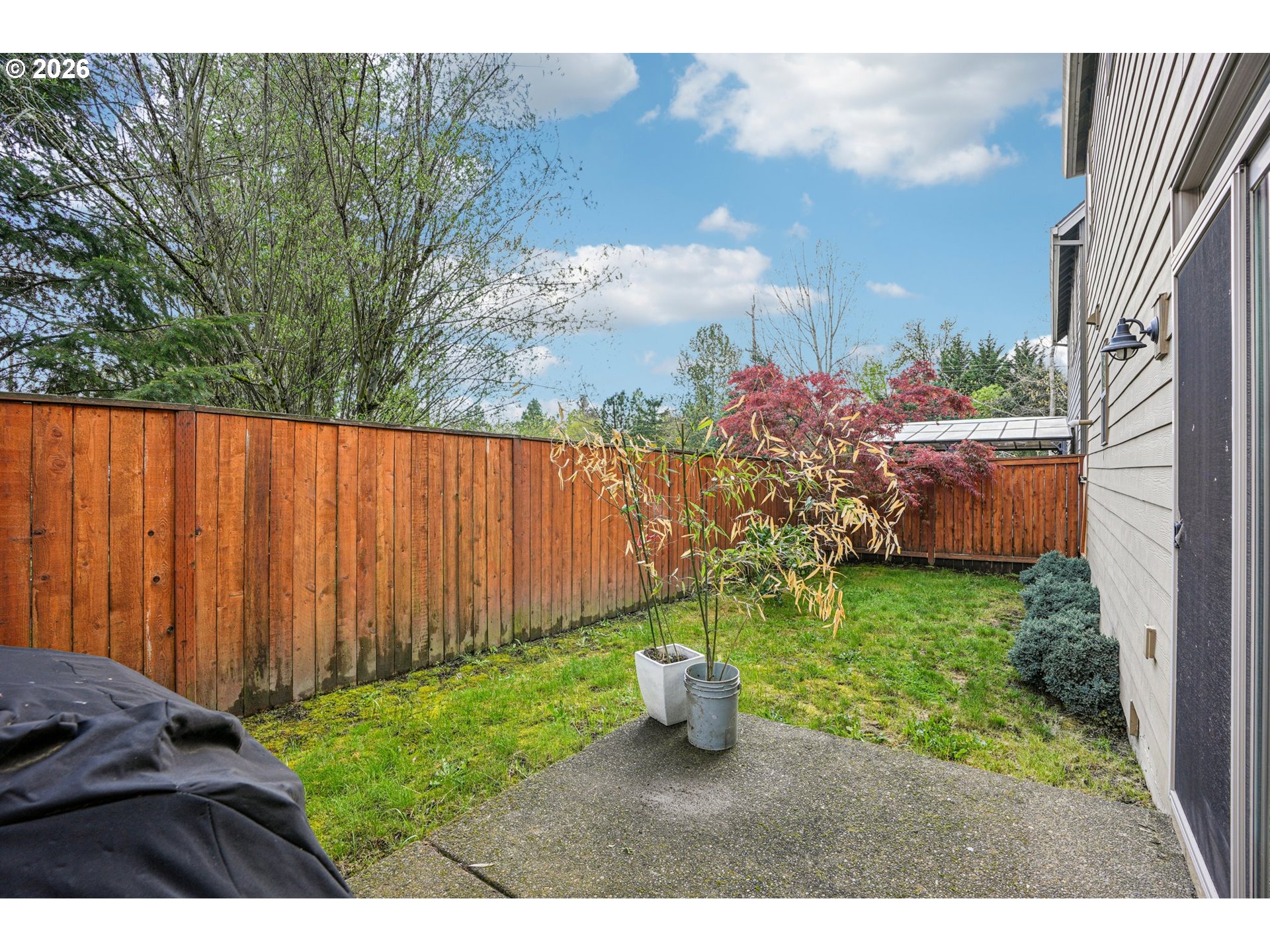 16958 Southwest Kavitt Lane Beaverton, OR 97078 - Photo 28 of 30 a view of a backyard with potted plants and large trees