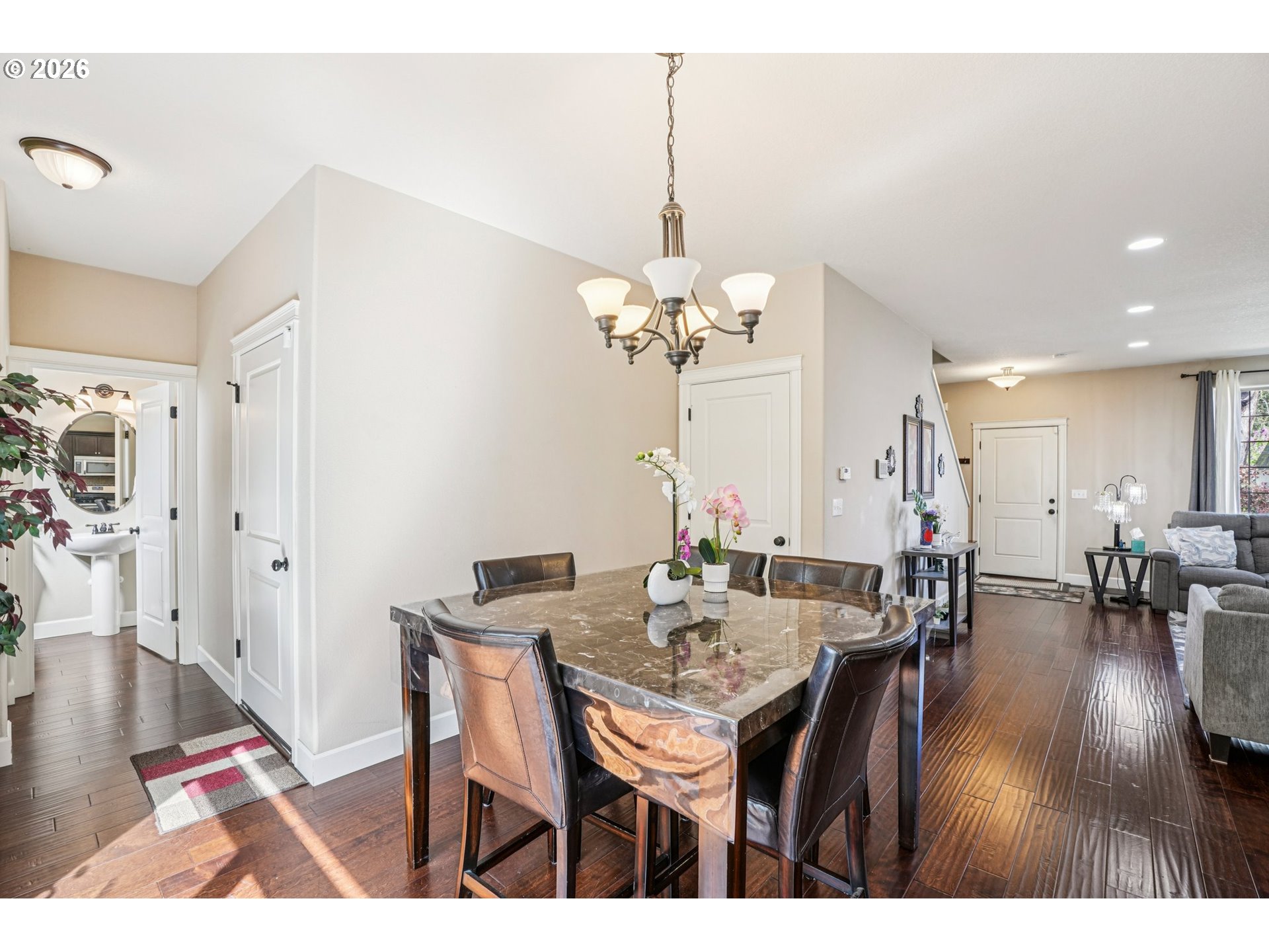 16958 Southwest Kavitt Lane Beaverton, OR 97078 - Photo 7 of 30 a dining room with furniture wooden floor and a chandelier