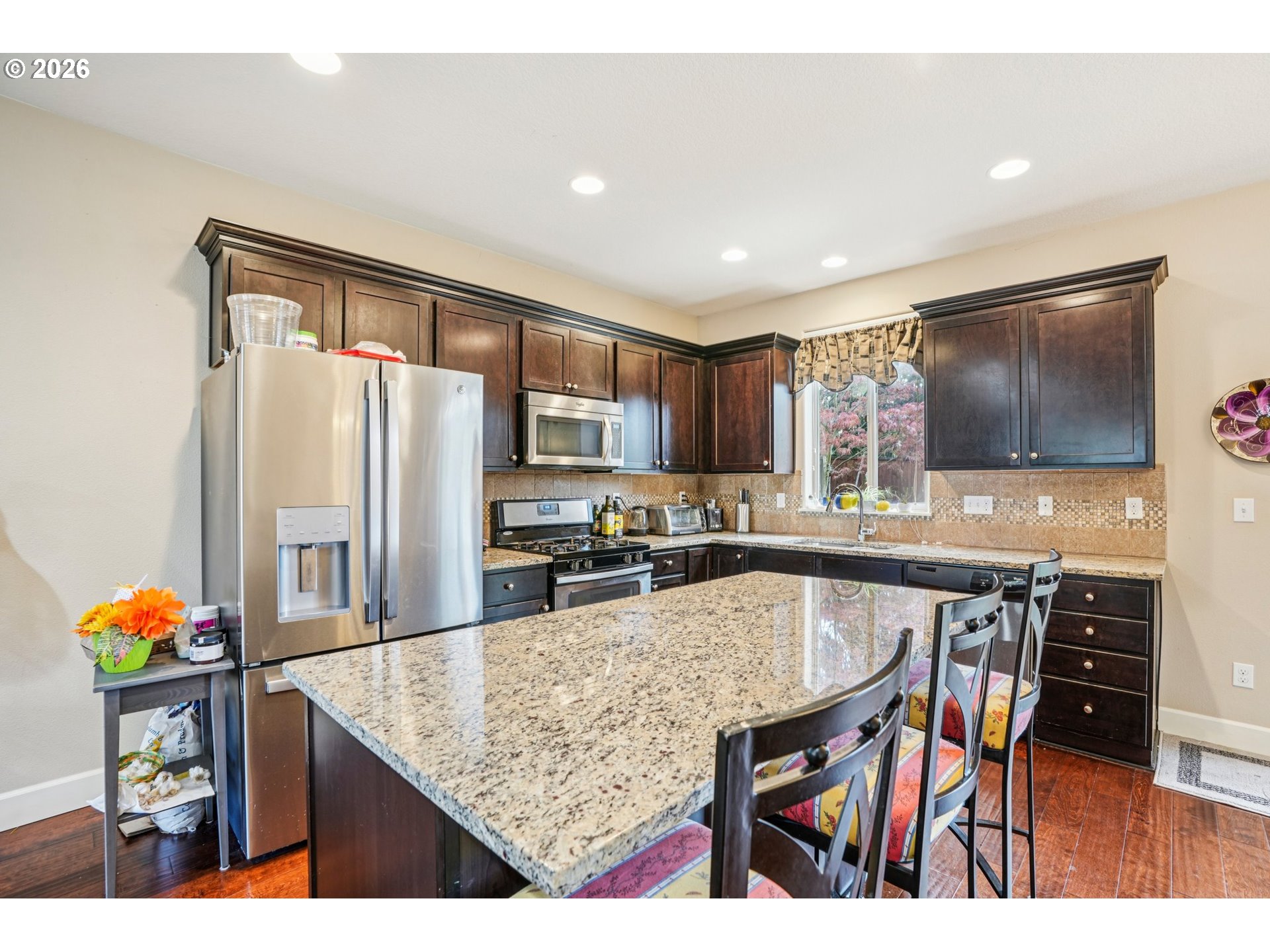 16958 Southwest Kavitt Lane Beaverton, OR 97078 - Photo 8 of 30 a kitchen with stainless steel appliances granite countertop sink refrigerator and microwave