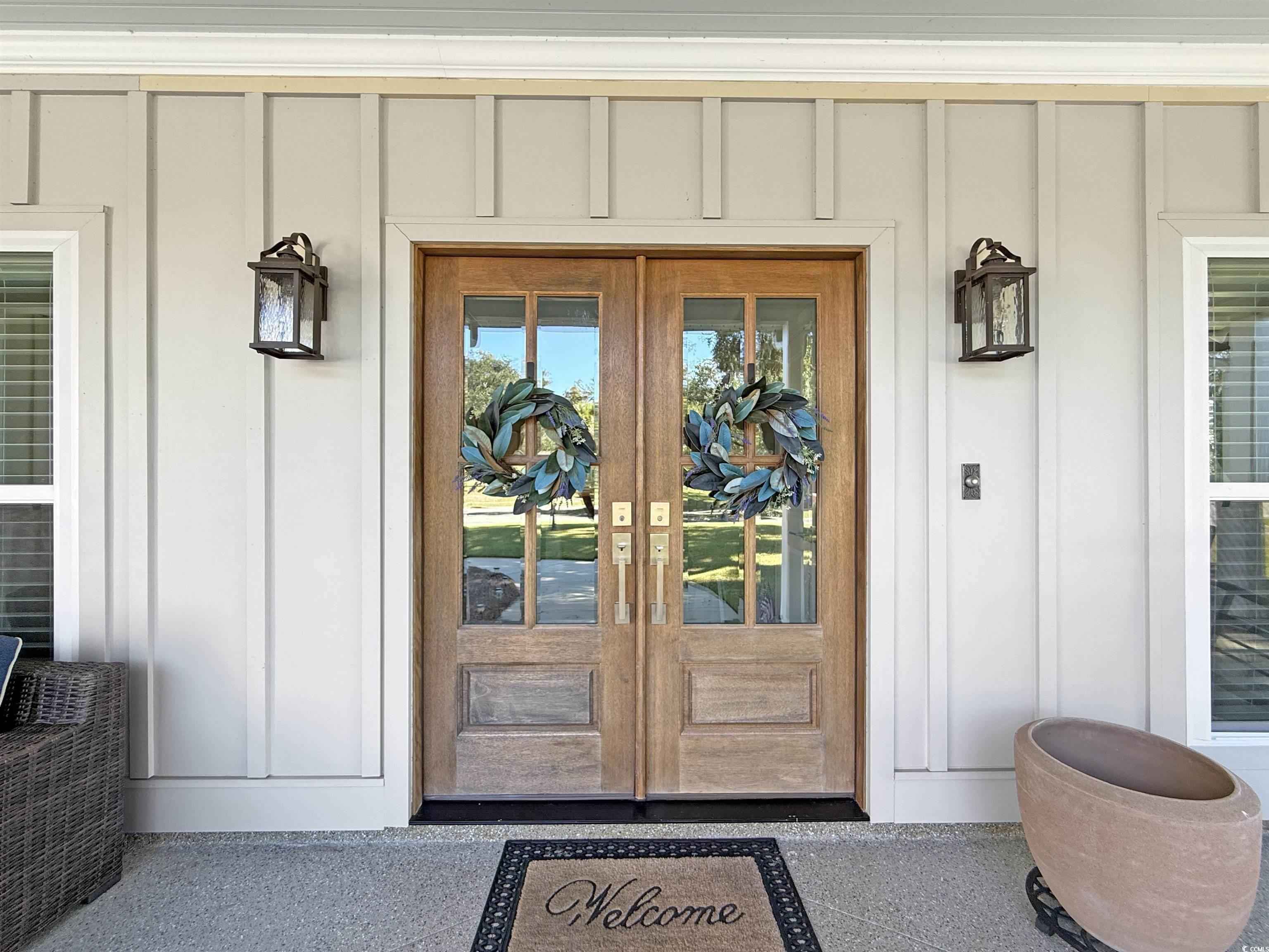 521 Oak Lawn Road Georgetown, SC 29440 - Photo 2 of 40 Doorway to property featuring french doors and board and batten siding