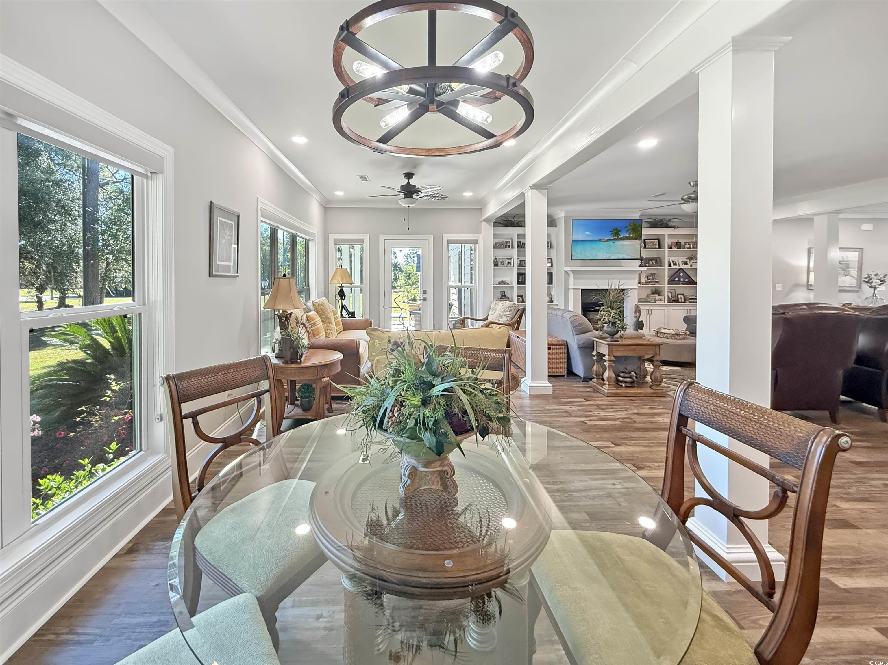 521 Oak Lawn Road Georgetown, SC 29440 - Photo 20 of 40 Dining space featuring wood finished floors, ornamental molding, a premium fireplace, recessed lighting, and built in features