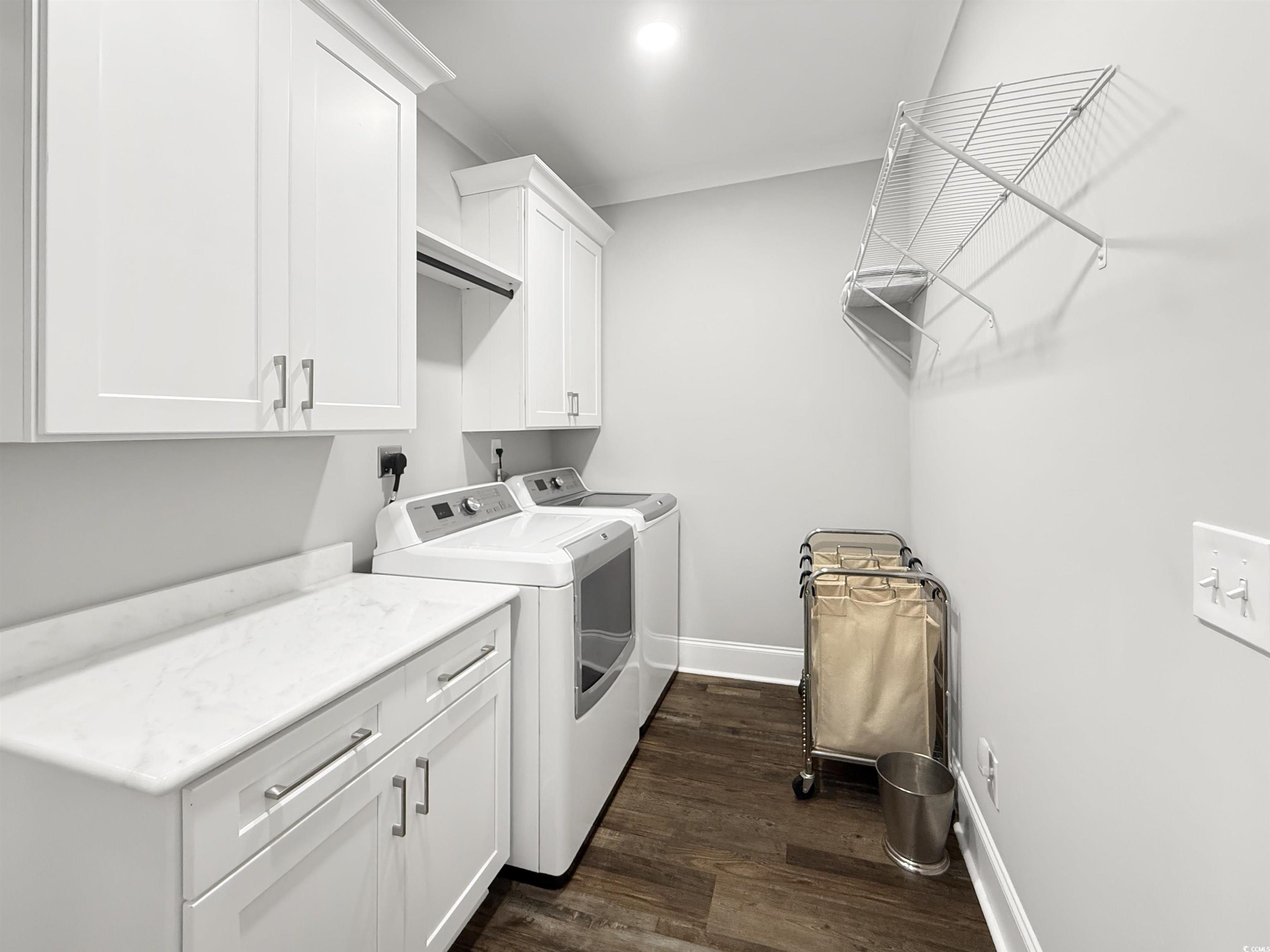 521 Oak Lawn Road Georgetown, SC 29440 - Photo 30 of 40 Laundry room with cabinet space, washing machine and dryer, and dark wood-style floors
