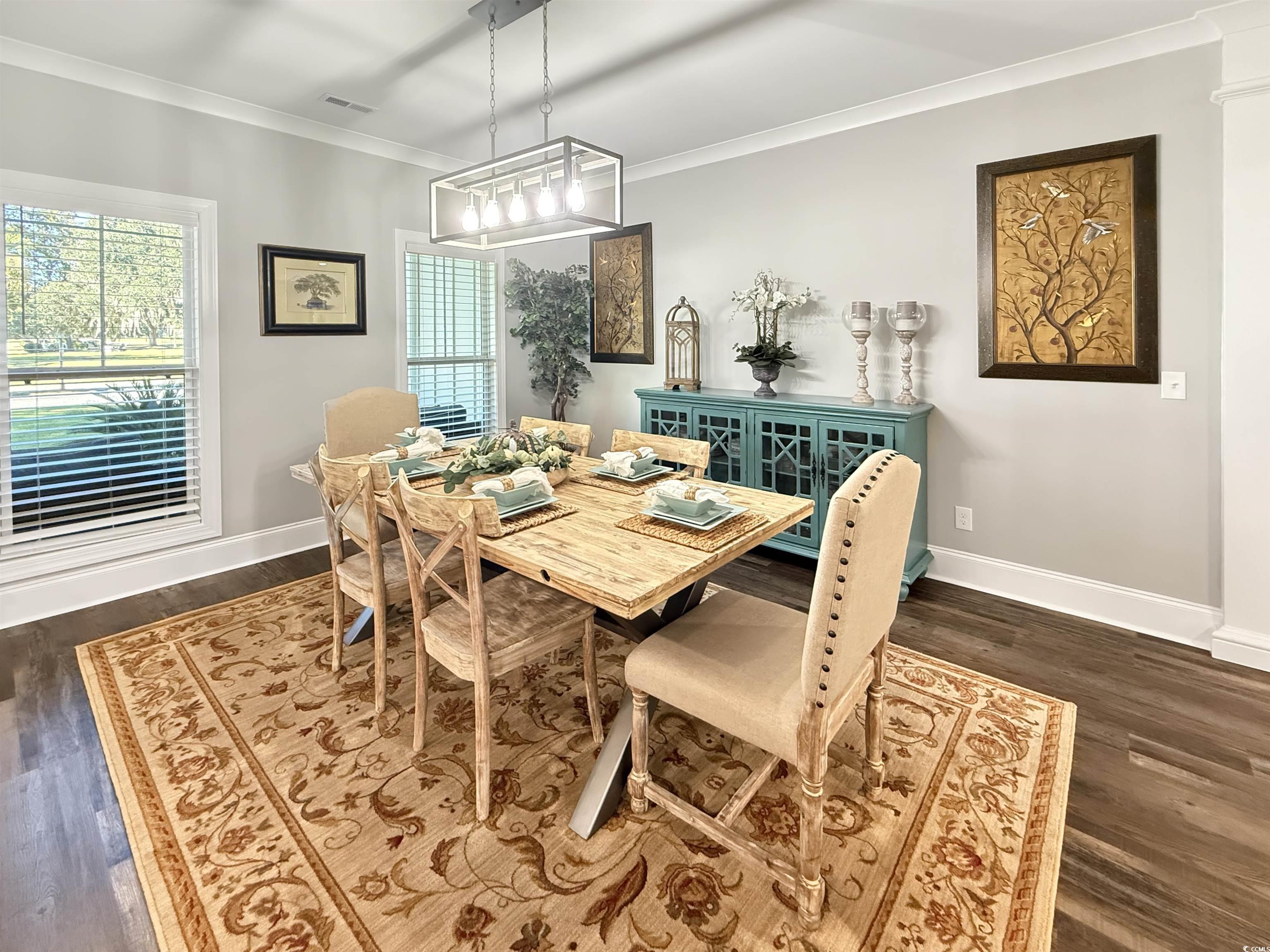 521 Oak Lawn Road Georgetown, SC 29440 - Photo 8 of 40 Dining area featuring ornamental molding and dark wood-style floors