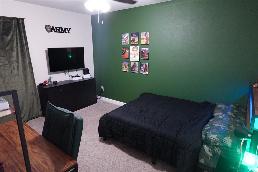1913 Cookes Lane Cleburne, TX 76033 - Photo 13 of 20 a bedroom with a bed and a flat screen tv