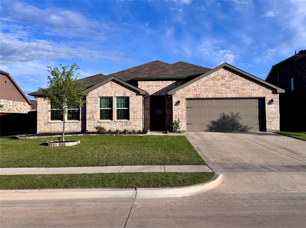 1913 Cookes Lane Cleburne, TX 76033 - Photo 2 of 20 a front view of a house with a garden