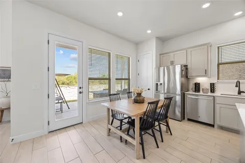 a view of a dining room with furniture and a window