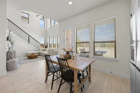 a view of a dining room with furniture and a window