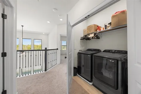 a view of a hallway with washer and dryer