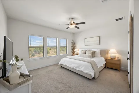 a spacious bedroom with a bed and a window