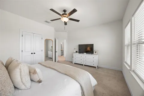 a bedroom with a bed and a flat screen tv