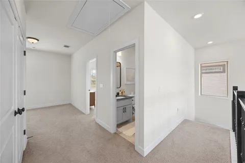 wooden floor in a room with a view of bathroom