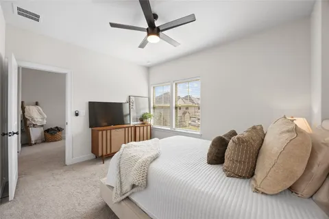 a bedroom with a bed and a television