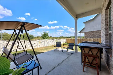 a view of chairs and tables in the patio