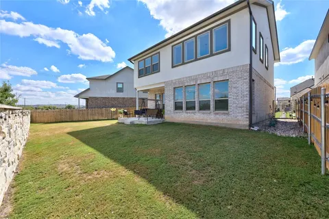a view of a house with a backyard