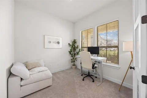a view of a livingroom with workspace and a couch
