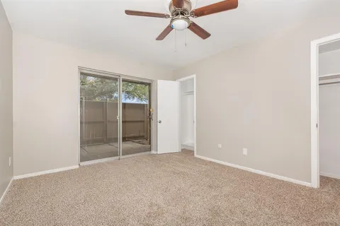 an empty room with closet and windows