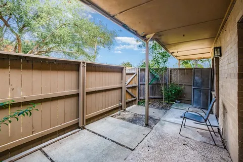 a backyard of a house with outdoor seating and green space