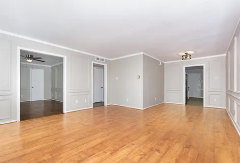 a view of an empty room and wooden floor