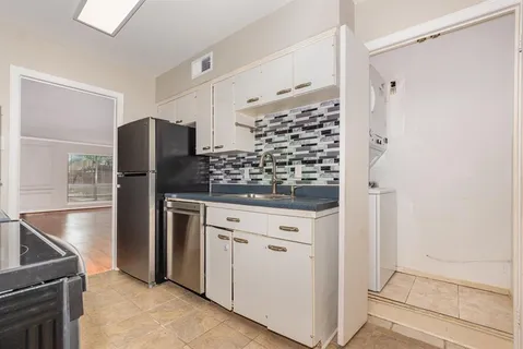 a kitchen with stainless steel appliances granite countertop a refrigerator and a stove