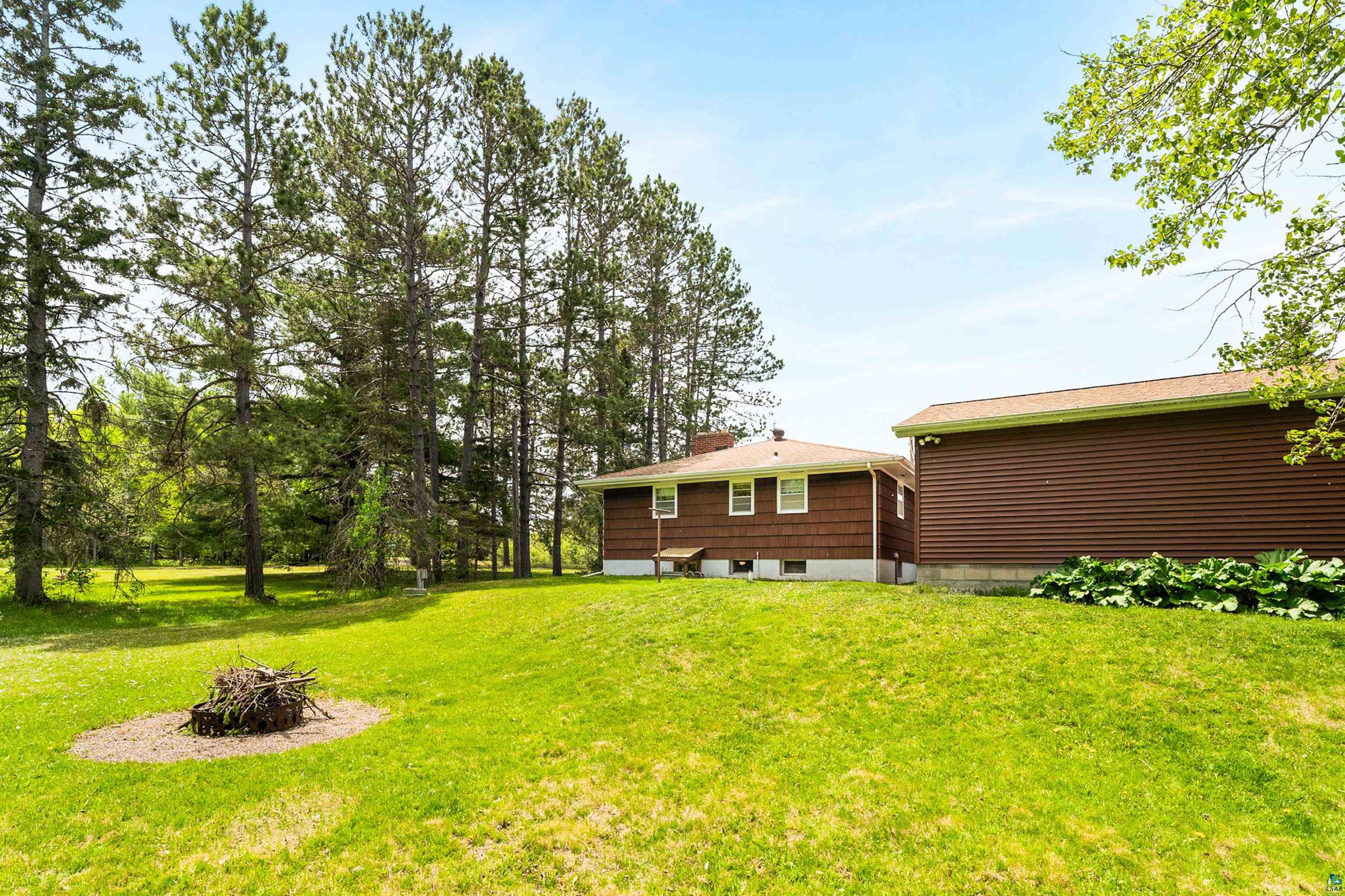 4808 Midway Road Duluth, MN 55811 - Photo 50 of 57 Expansive green lawn with mature evergreen trees bordering the property