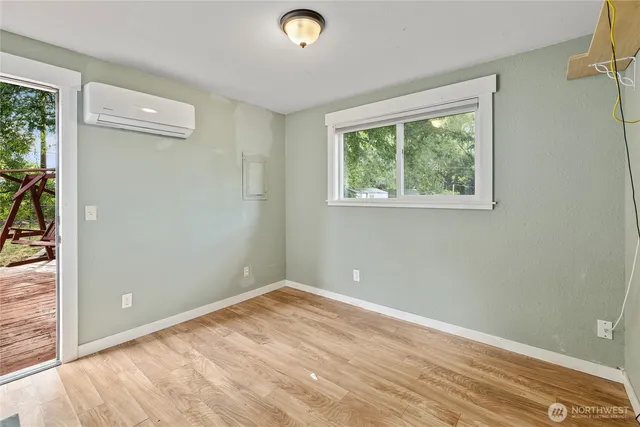 a view of a livingroom with wooden floor and window