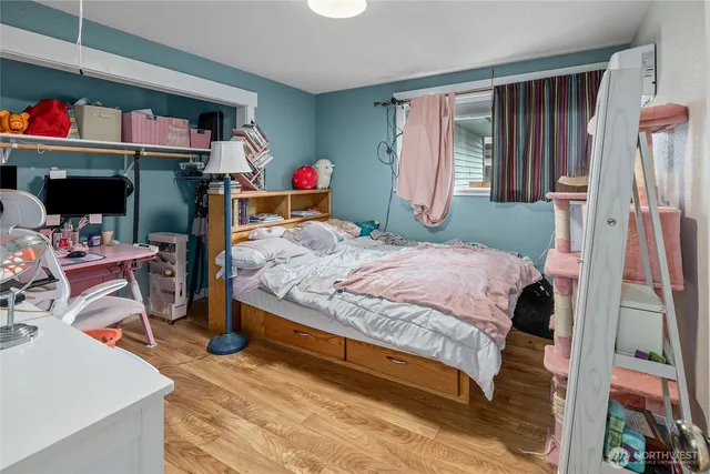 a bedroom with a bed and a window