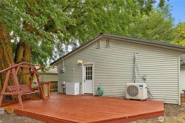 a view of a house with backyard and sitting area