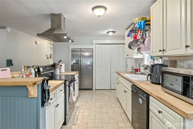 a kitchen with stainless steel appliances granite countertop a sink and cabinets