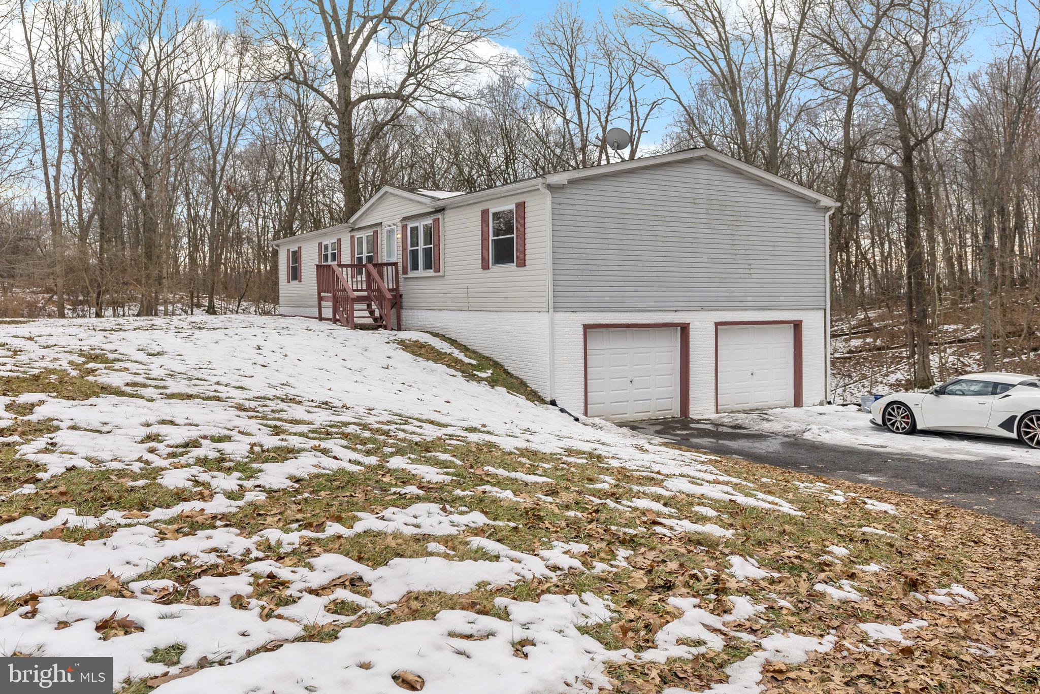 a view of a house with a yard covered in snow