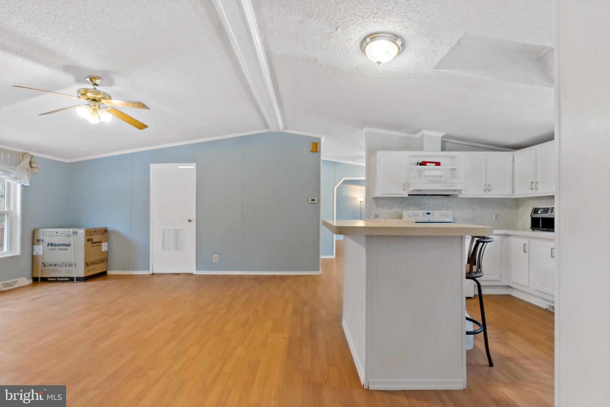 233 Short Road Kearneysville, WV 25430 - Photo 12 of 36 a kitchen with kitchen island granite countertop a stove a sink and a refrigerator