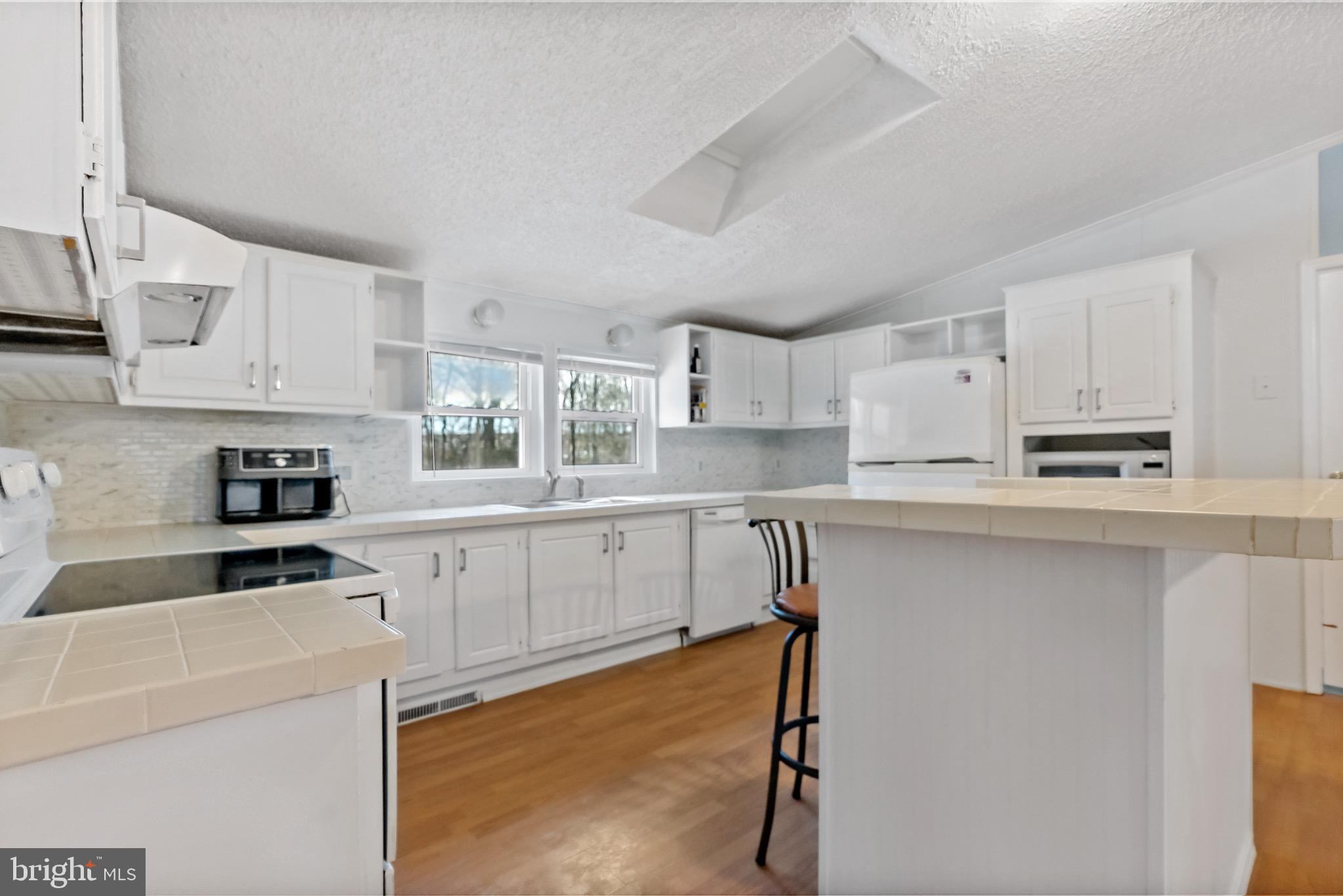 233 Short Road Kearneysville, WV 25430 - Photo 15 of 36 a kitchen with stainless steel appliances cabinets a sink and a stove