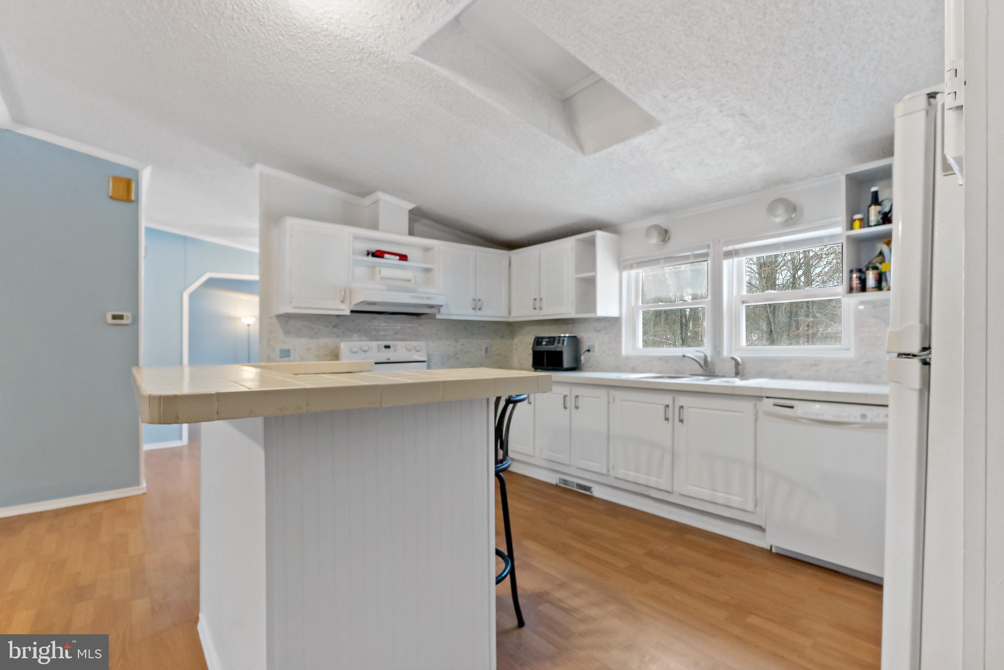 233 Short Road Kearneysville, WV 25430 - Photo 16 of 36 a kitchen with stainless steel appliances white cabinets and a sink
