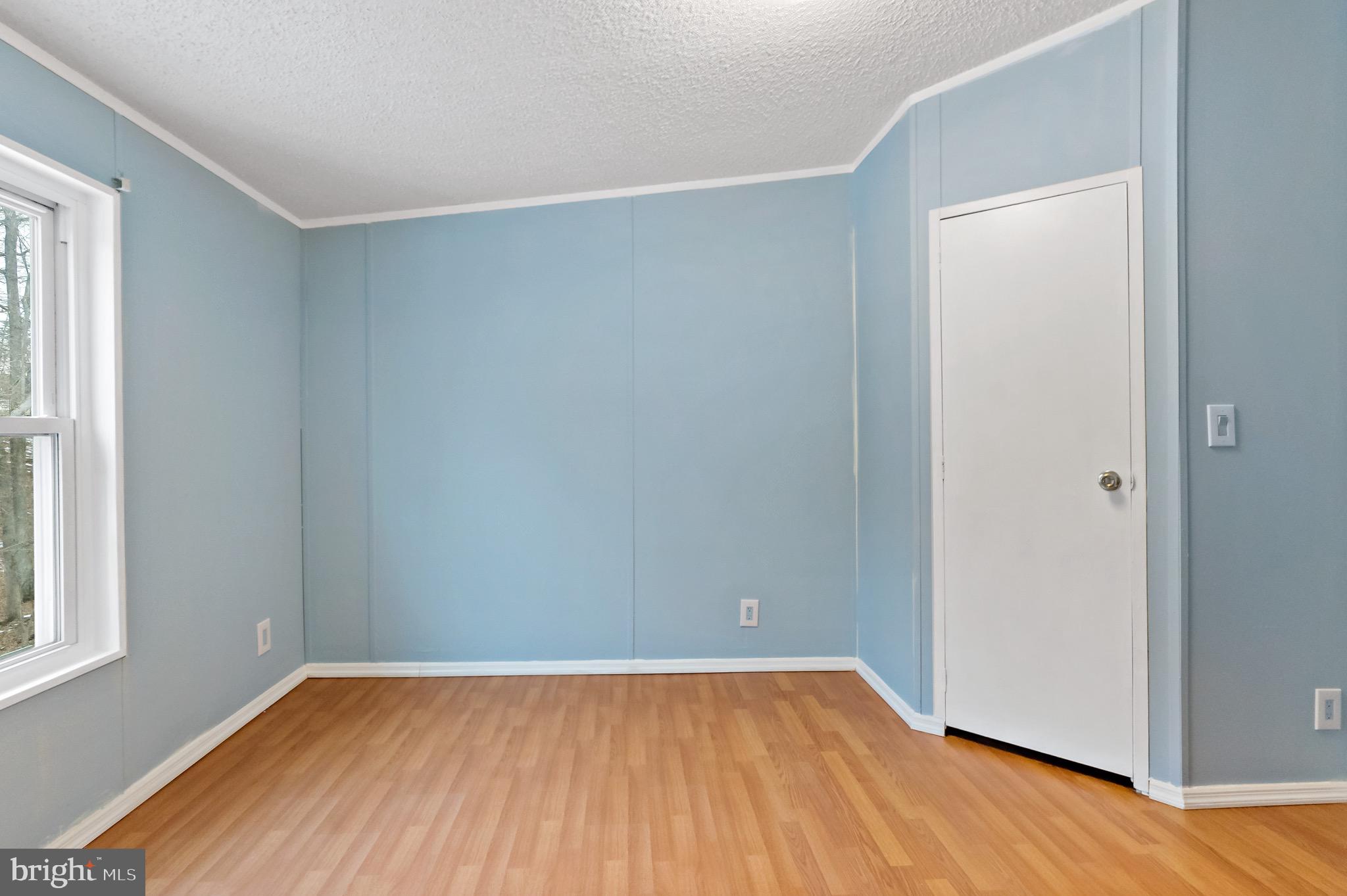 233 Short Road Kearneysville, WV 25430 - Photo 25 of 36 an empty room with wooden floor and windows