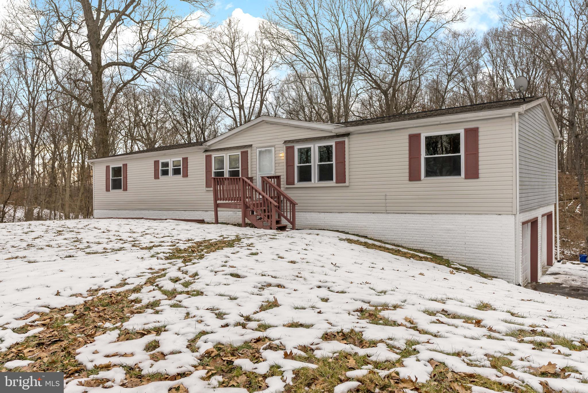 233 Short Road Kearneysville, WV 25430 - Photo 3 of 36 a front view of a house with a yard covered in snow